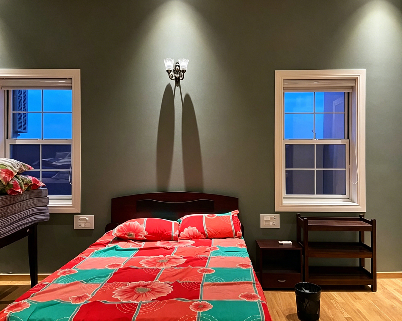 Georgia Windows & Doors white aluminum double hung sash windows symmetrical bedroom installation — colonial grid bars flanking bed sage green wall