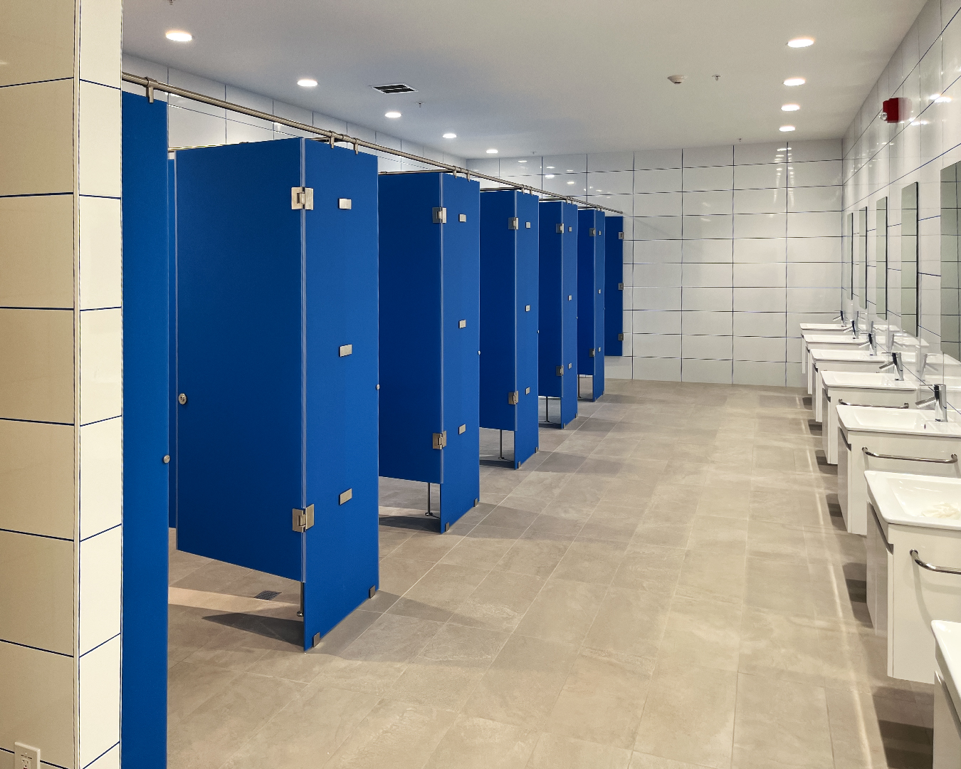 Georgia Windows & Doors custom commercial restroom partitions with durable blue panels and heavy-duty hardware, providing safety, privacy and modern functionality for institutional facilities